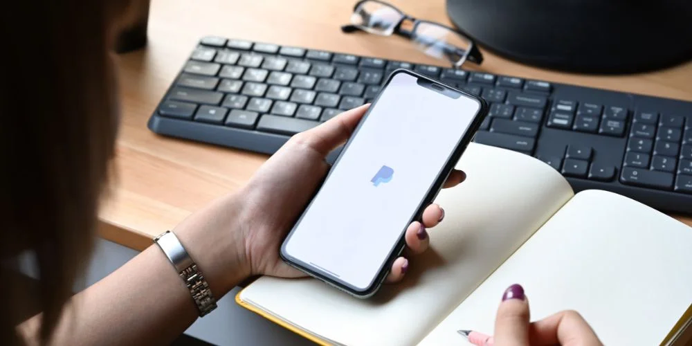 Woman using PayPal on a smartphone