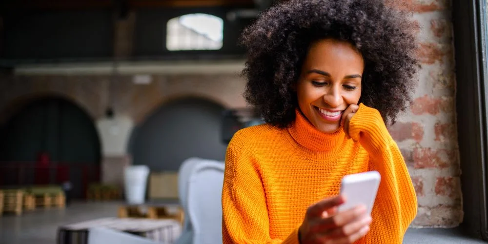 Woman using Voxer to send messages on her phone
